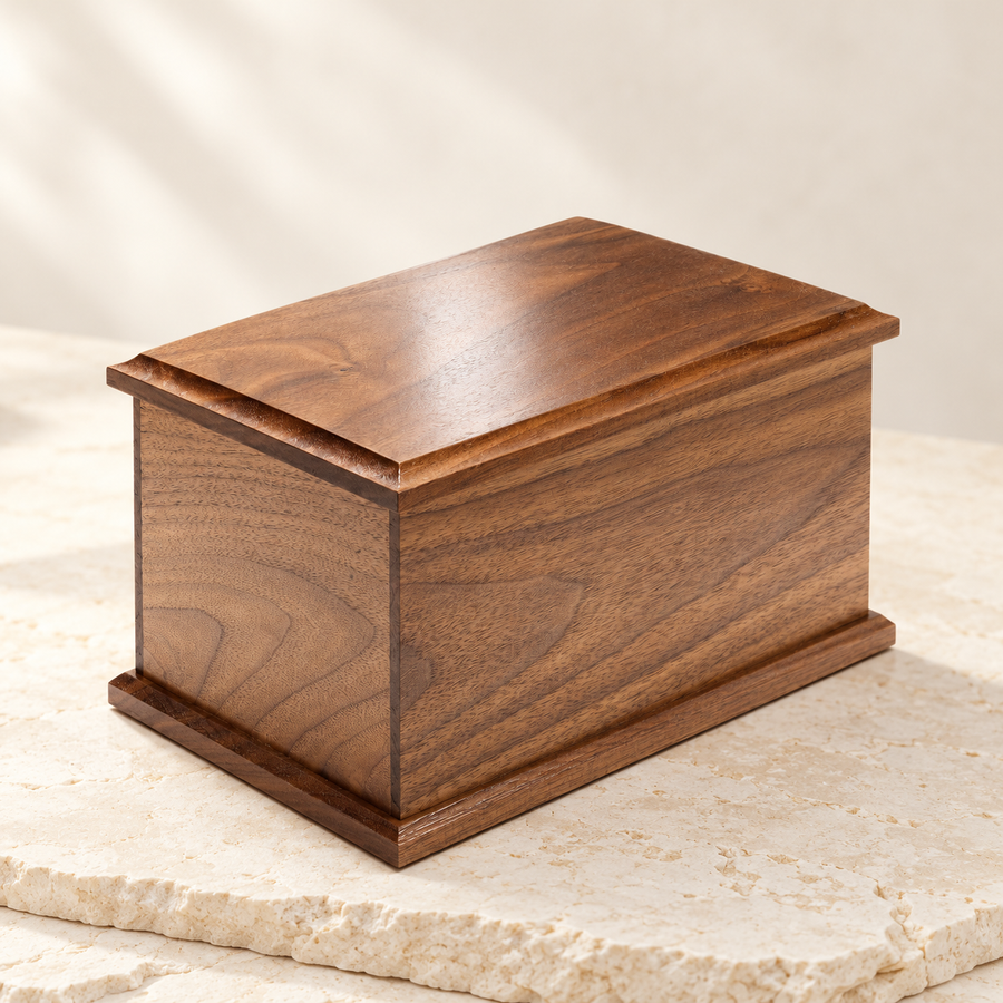 Walnut cremation urn on a cream stone tabletop