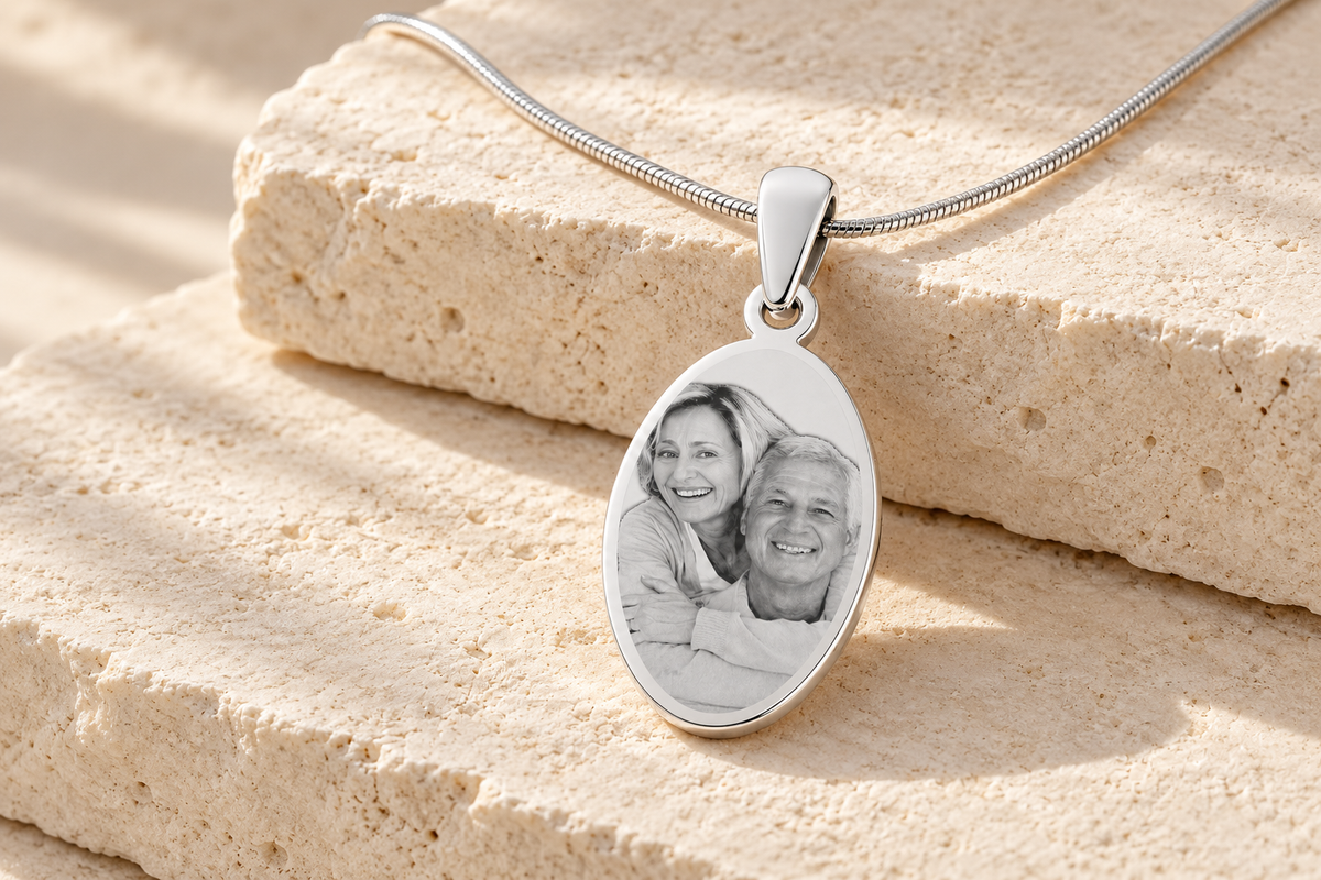 Silver oval photo engraved pendant featuring a couple on cream limestone