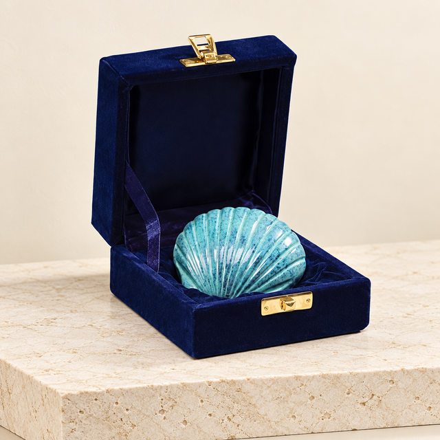 patina shell keepsake urn on a cream limestone background