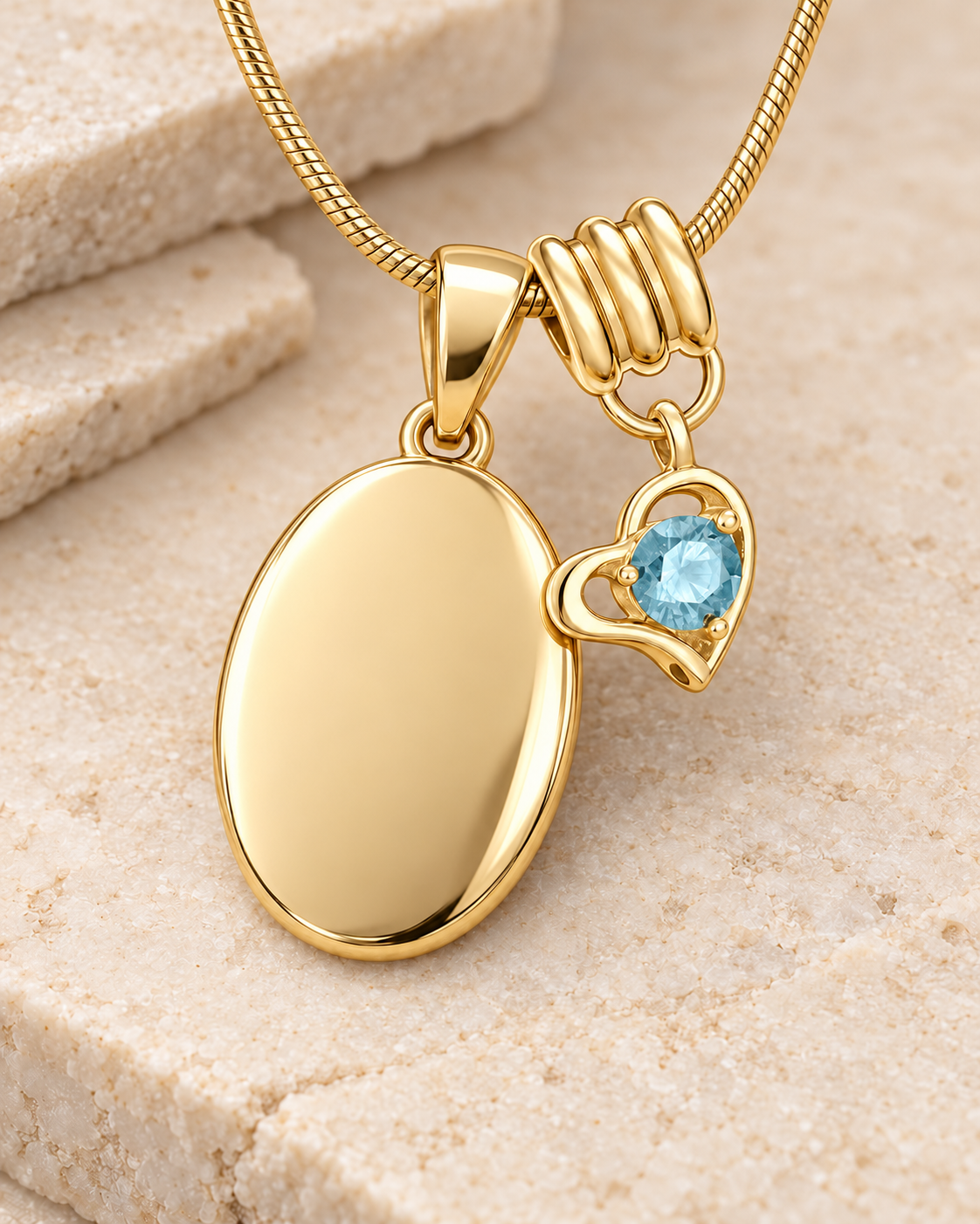 March gold birthstone heart hanger with an illustrative matching oval pendant; display pendant and chain sold separately.