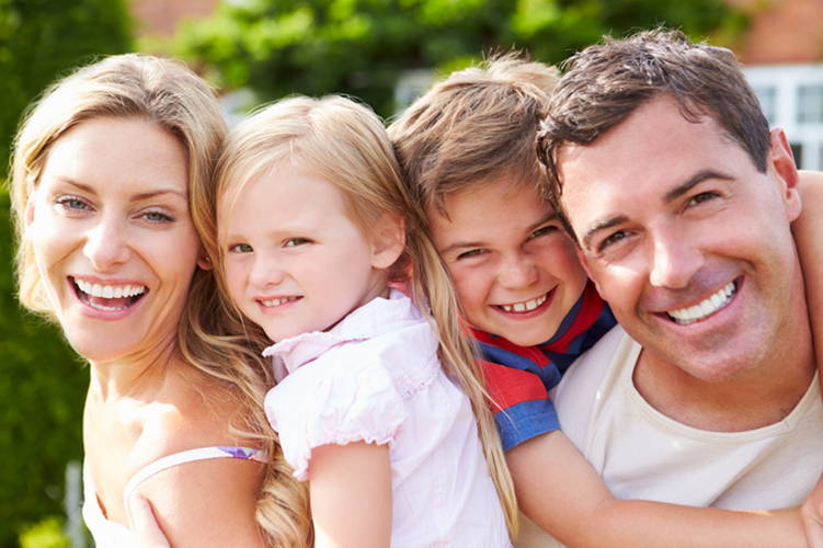 Four people grouped together in a family photo