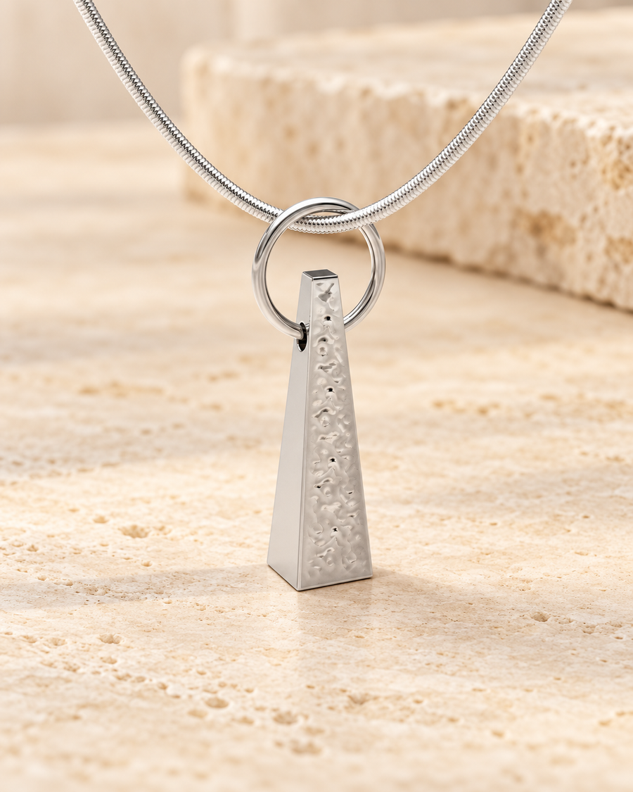 Silver version of the custom taper pendant on cream stone