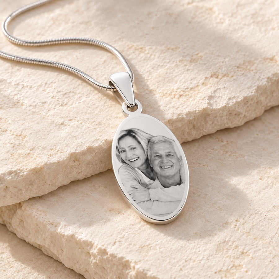 Silver oval photo necklace with an engraved portrait on white slate