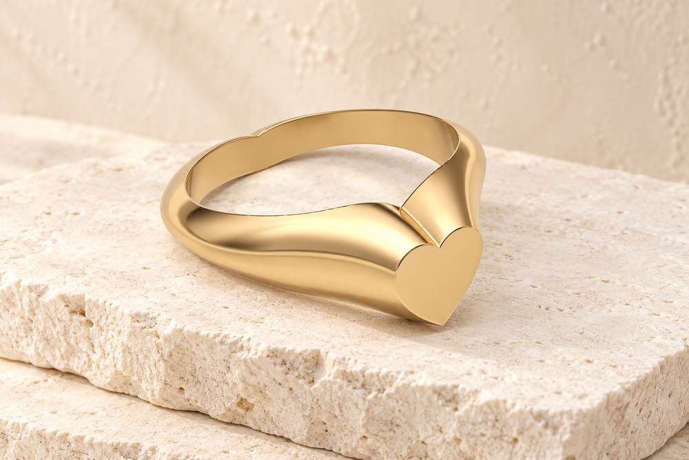 Solid 14k gold heart signet Forever Sealed ring on cream stone.