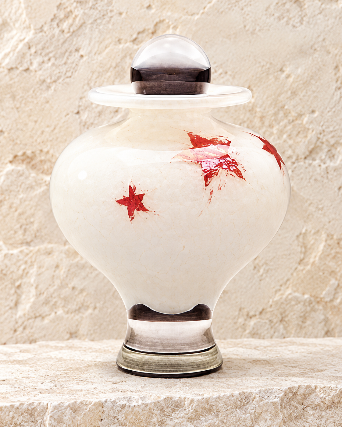 little star childrens cremation urn on cream stacked stone, portrait product photograph