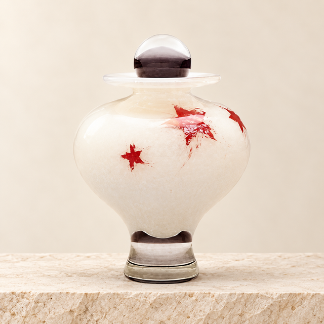 little star childrens cremation urn on a cream limestone background