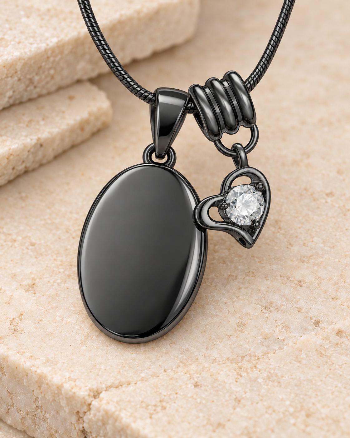 April black birthstone heart hanger with an illustrative matching oval pendant; display pendant and chain sold separately.